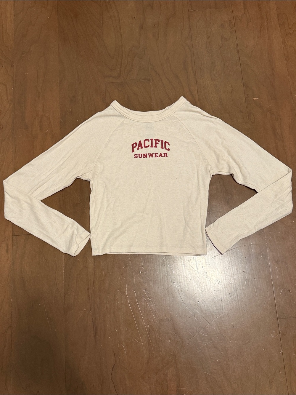 Pacific Sunwear Cream Cropped Long-Sleeve Top with Red Logo
